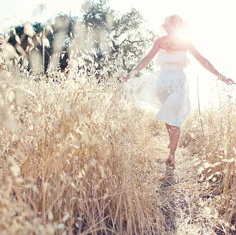 Woman Walking through Wheat Field w/ Arms Out | Rooted Counseling and Wellness: Home | Therapy and Wellness Draper Utah | Counseling Draper Utah | Group Therapy Salt Lake City