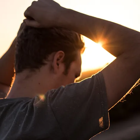 Man with Hands on His Head at Sunset | Rooted Counseling and Wellness: Home | Therapy Draper | Therapy and Wellness Draper Utah | Couples Therapy Salt Lake City