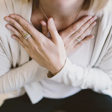 Woman with Both Hands Laying on Her Chest | Rooted Counseling and Wellness: About Us | Counseling in Draper | Rooted Therapy and Wellness | Therapy in Draper & South Jordan