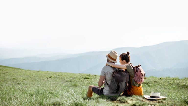 Couple Affectionately Sitting on Hill | What is Attachment Based Therapy | Rooted Counseling & Wellness | Attachment Based Therapies | Counseling | Draper Therapy & Wellness