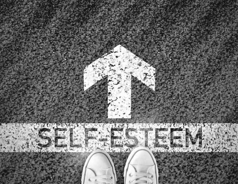 Shoes Behind Arrow Pointing to Self-Esteem | The Power of Boundaries in Boosting Self-Esteem | Rooted Counseling & Wellness | Boundaries Mind Body Wellness | Maintenance of Boundaries